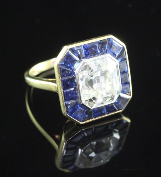 A mid 20th century gold, asscher cut diamond and sapphire set dress ring, size H.